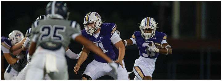A group of football players on a field. Description generated by AI
