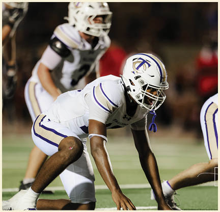 A football player is kicking a football on a field. Description generated by AI