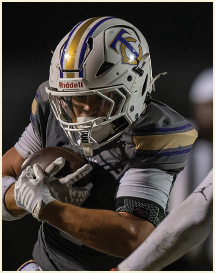 A football player wearing a black jersey with the number 11 on it. Description generated by AI
