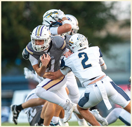 A football player is kicking a football on a field. Description generated by AI
