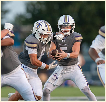 A football player is kicking a football on a field. Description generated by AI