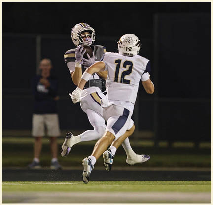 A football player is kicking a football on a field. Description generated by AI
