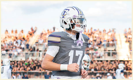 A football player wearing a black jersey with the number 11 on it. Description generated by AI