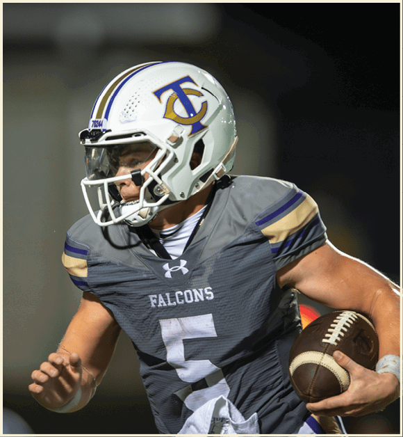 A football player wearing a black jersey with the number 11 on it. Description generated by AI