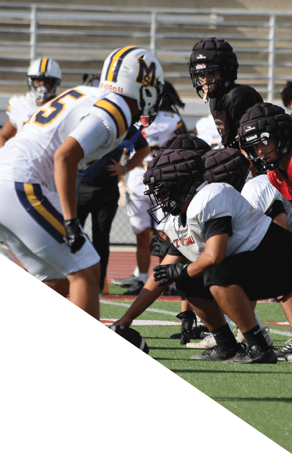 A football player is kneeling on the field, holding his helmet in his hands. AI generated content