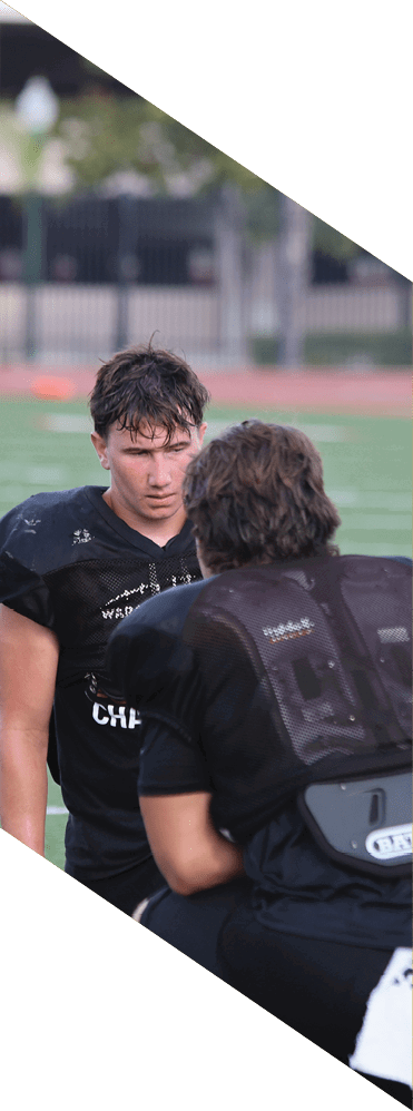 Two young men wearing football uniforms and making hand gestures. AI generated content