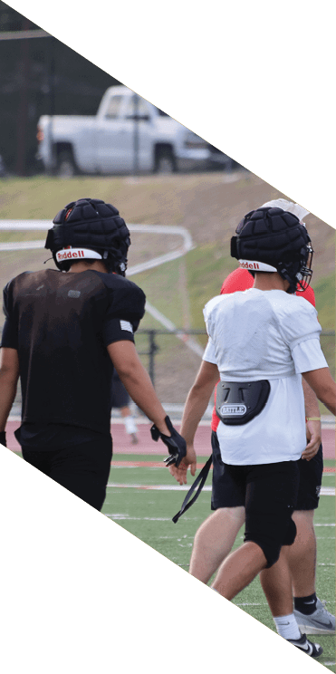 A group of football players wearing headphones and smiling. AI generated content