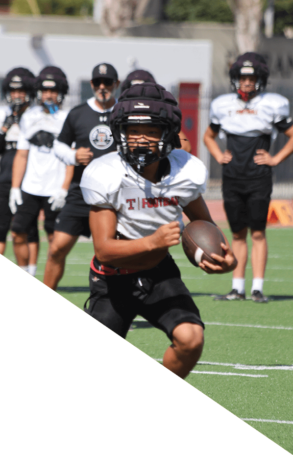 A football player is kneeling on the field, holding his helmet in his hands. AI generated content
