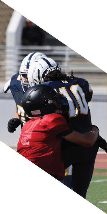 Two football players are on the field, one jumping in the air while the other is running. A referee is also present, watching the play. AI generated content