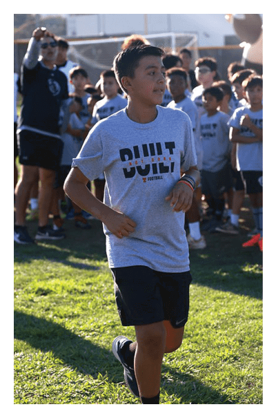 A young man wearing a football jersey with the name Vista on the back. AI generated content