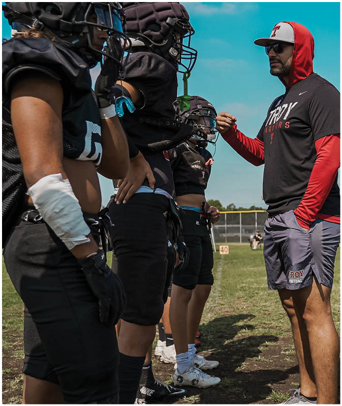 A group of football players on a field. Description generated by AI