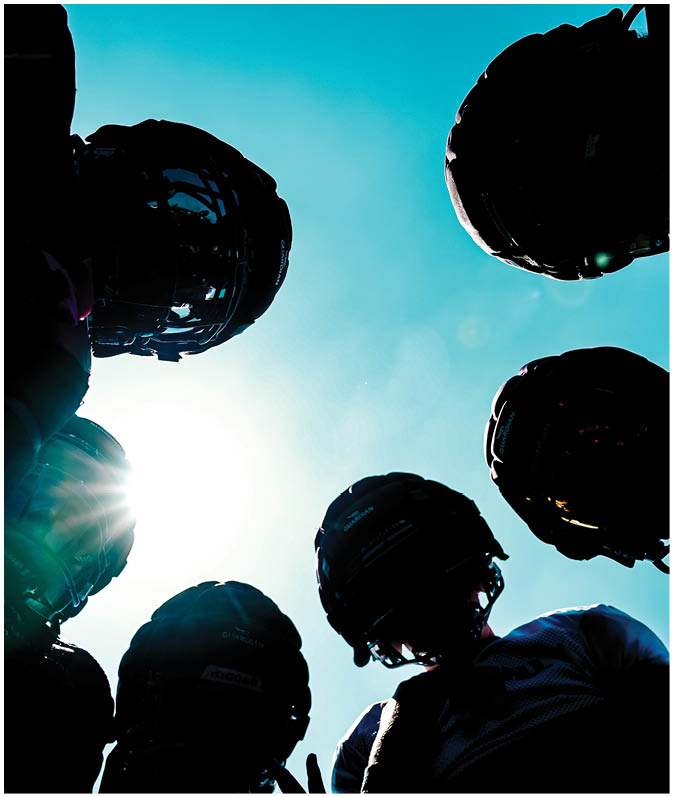 A group of football players on a field. Description generated by AI