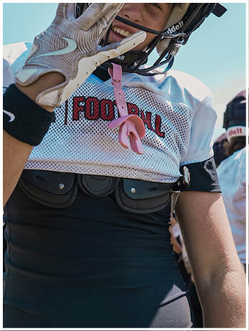 A football player wearing a blue and red jersey. Description generated by AI
