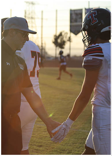 A football player wearing a blue jersey with the number 58 on it. Description generated by AI