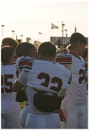 A group of football players celebrating a touchdown. Description generated by AI