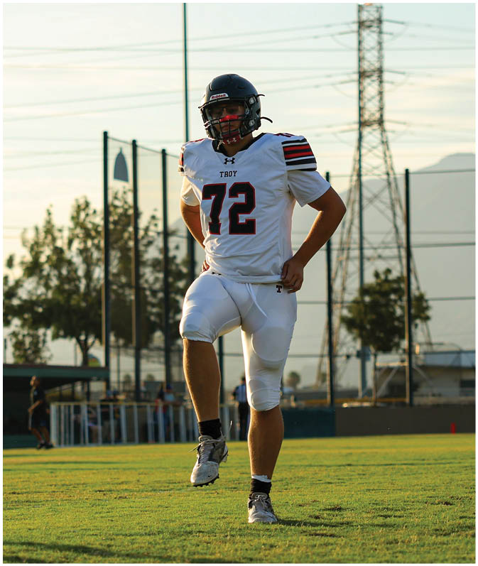 A group of football players on a field. Description generated by AI