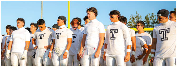 A group of football players on a field. Description generated by AI