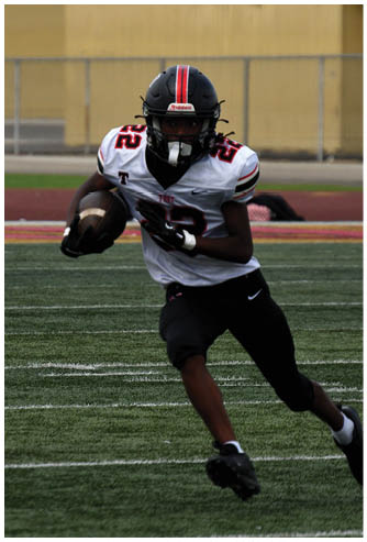 A football game is being played on a field. Description generated by AI