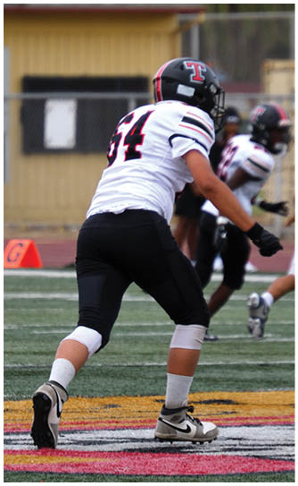 A football player catching a ball. Description generated by AI
