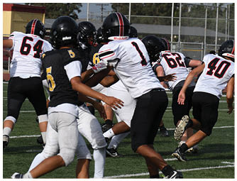 A group of football players on a field. Description generated by AI
