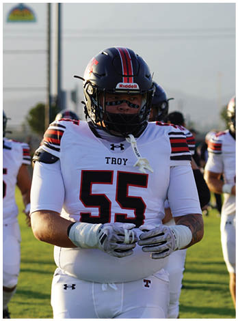 A football player wearing a blue jersey with the number 58 on it. Description generated by AI