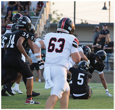 A football player wearing a blue jersey with the number 58 on it. Description generated by AI