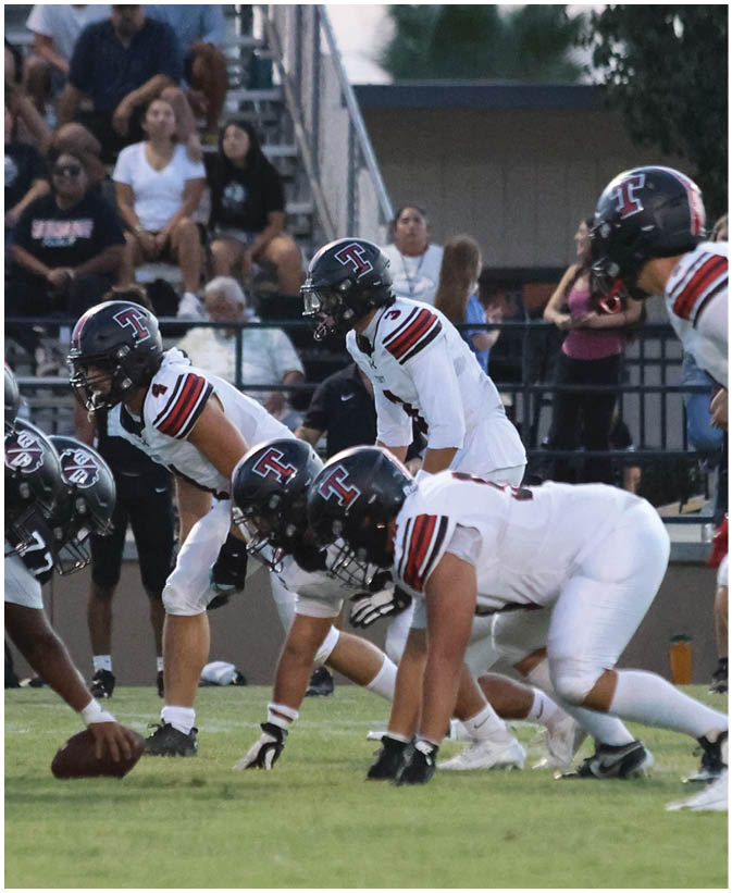 A group of football players on a field. Description generated by AI