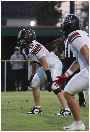 A group of football players celebrating a touchdown. Description generated by AI