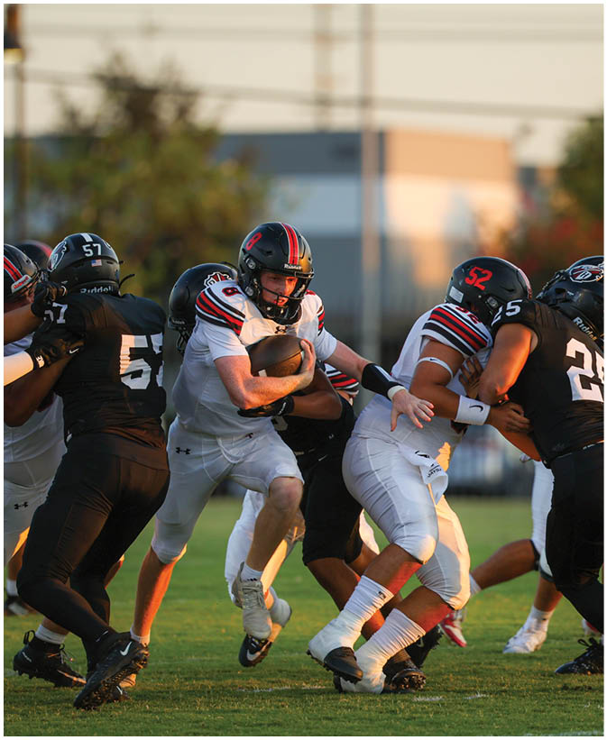 A group of football players on a field. Description generated by AI