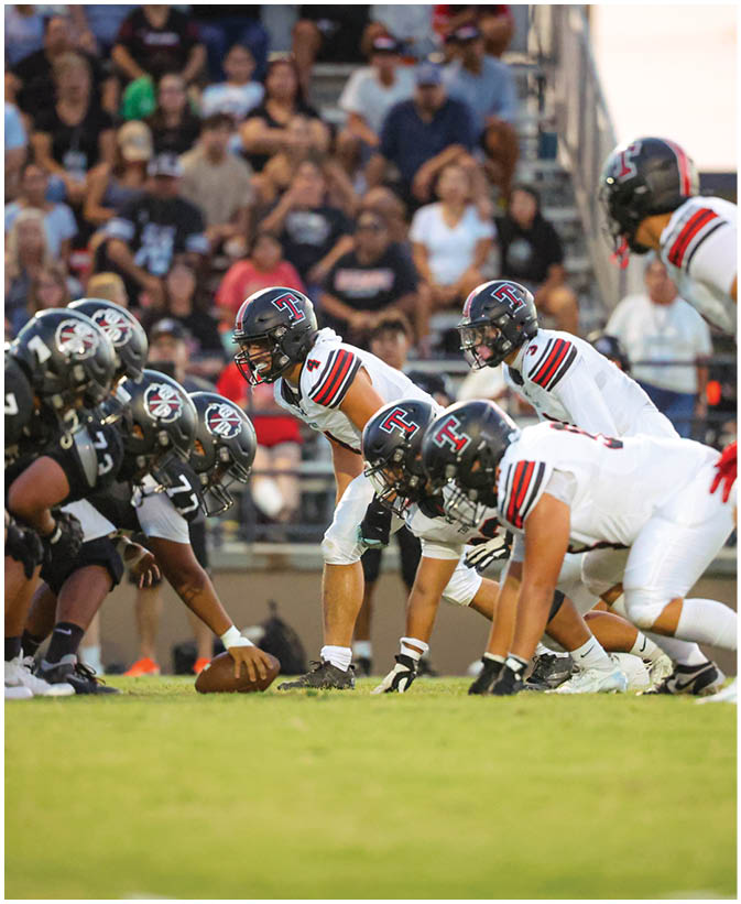 A group of football players on a field. Description generated by AI