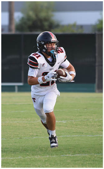 A football player catching a ball. Description generated by AI
