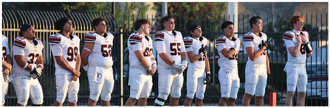 A group of football players on a field. Description generated by AI