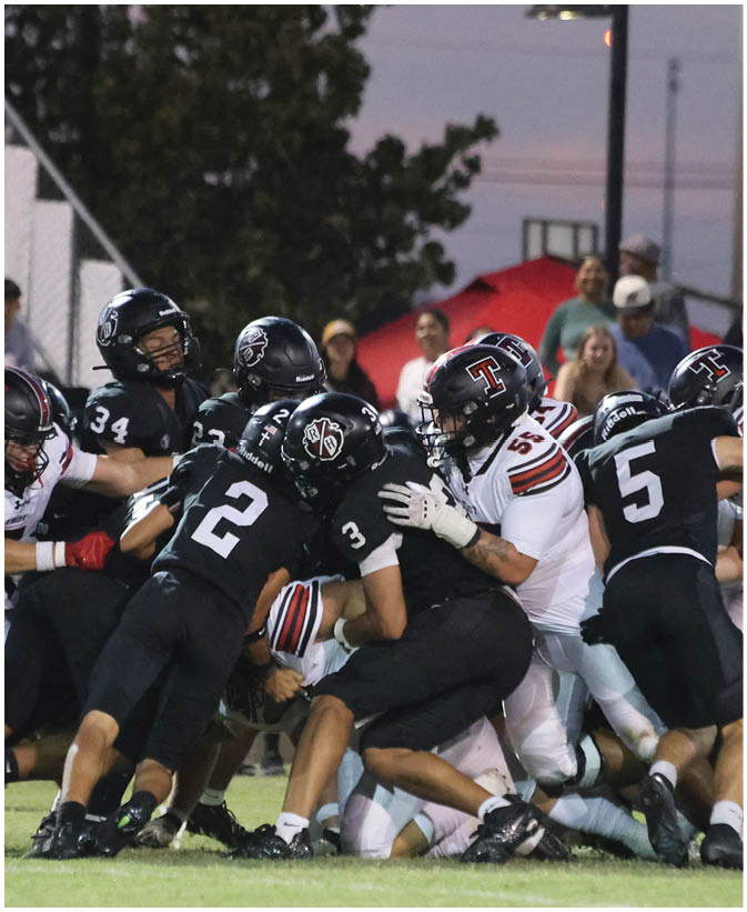 A group of football players on a field. Description generated by AI