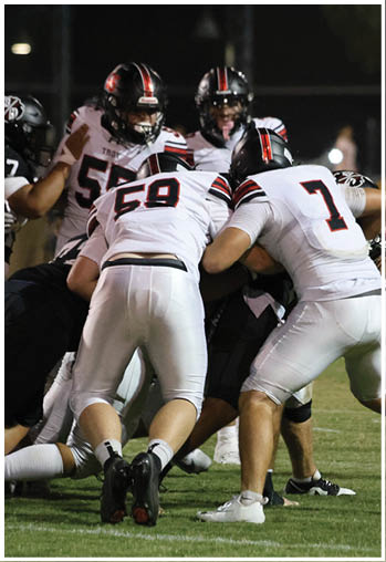 A group of football players celebrating a touchdown. Description generated by AI