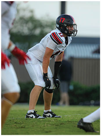A football player wearing a blue jersey with the number 58 on it. Description generated by AI
