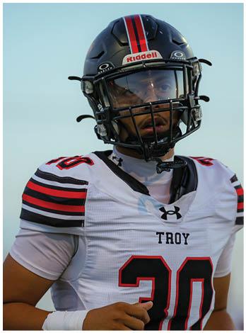 A football player wearing a blue jersey with the number 58 on it. Description generated by AI