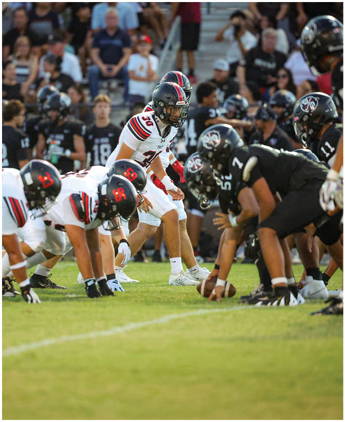 A group of football players on a field. Description generated by AI