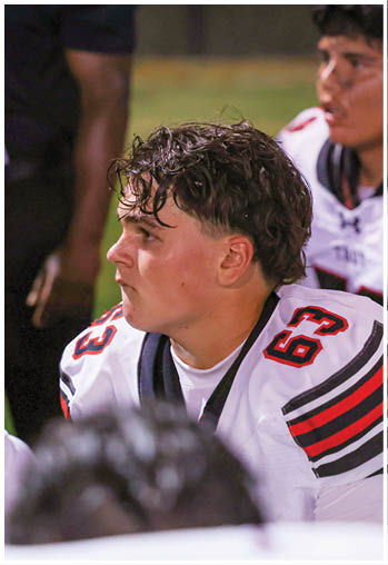 A group of football players celebrating a touchdown. Description generated by AI