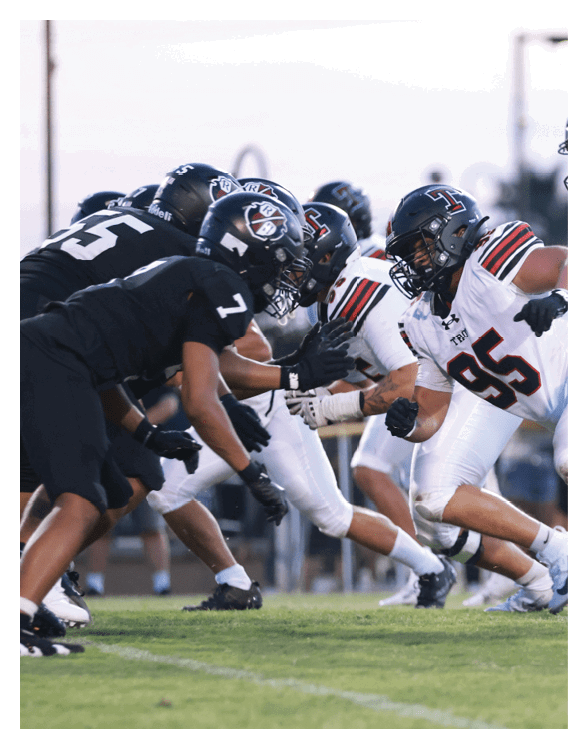 A football player wearing a helmet and white uniform is holding his helmet above his head. AI generated content