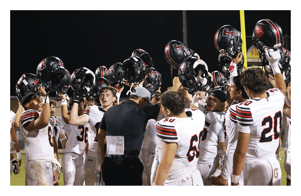 A group of football players wearing headphones and smiling. AI generated content