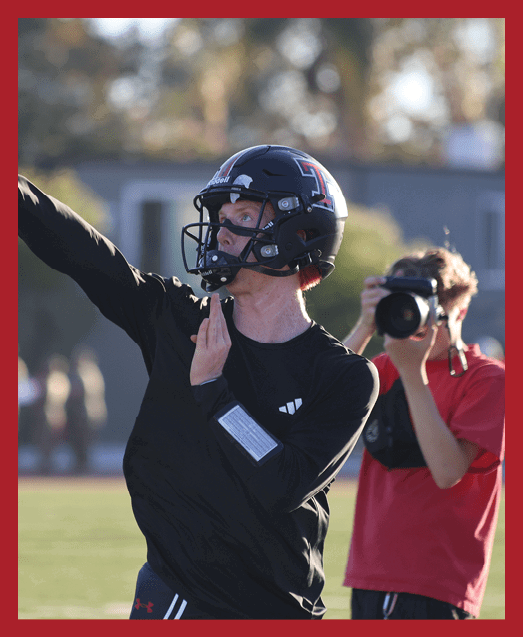 A football player in a white uniform is running with a football in his hand. AI generated content