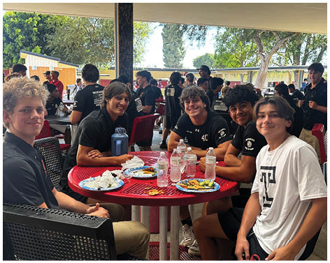A group of football players celebrating a touchdown. Description generated by AI
