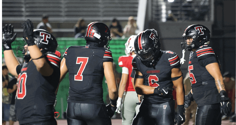 A group of people are kneeling on a field, possibly in a football game. AI generated content