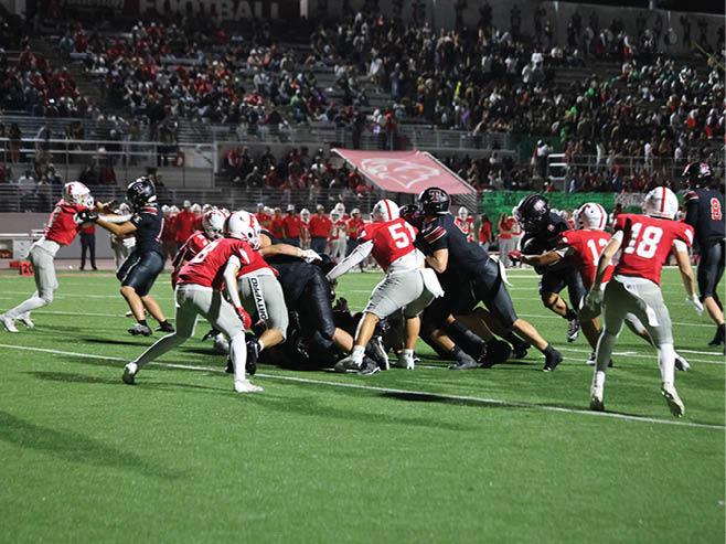 A group of football players in black and white uniforms are on the field. AI generated content