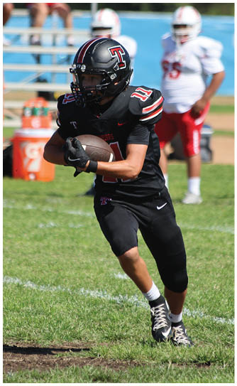 A football player catching a ball. Description generated by AI