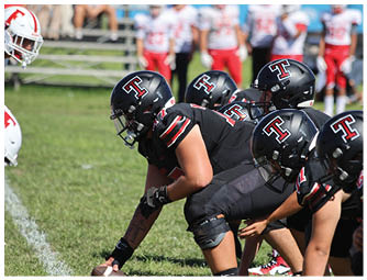 A group of football players on a field. Description generated by AI