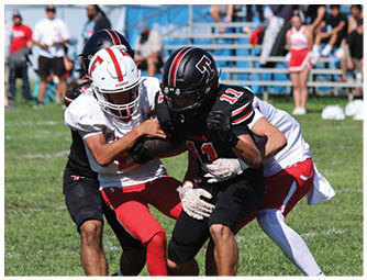 A group of football players on a field. Description generated by AI