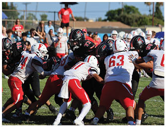 A group of football players on a field. Description generated by AI
