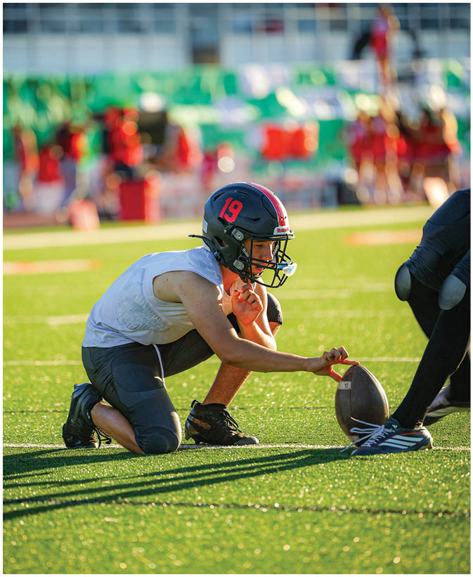 A group of football players on a field. Description generated by AI