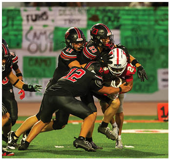 A football player running on the field. Description generated by AI